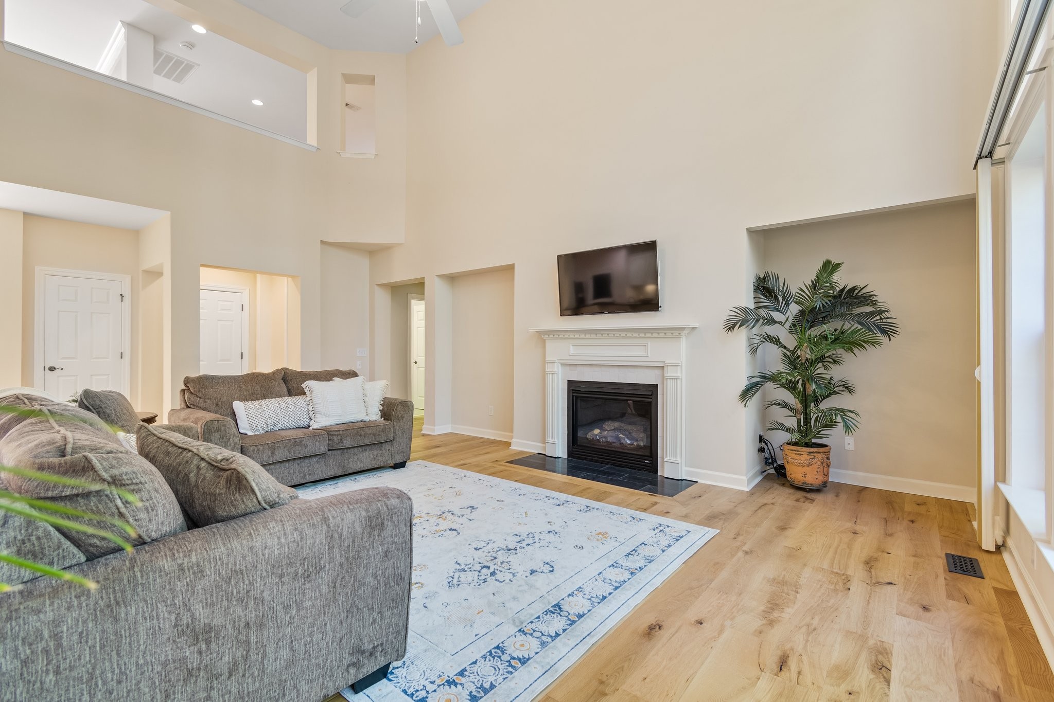 5028 Abington Ridge Lane Franklin, TN 37067 - Photo 18 of 68 a living room with furniture a fireplace and a potted plant
