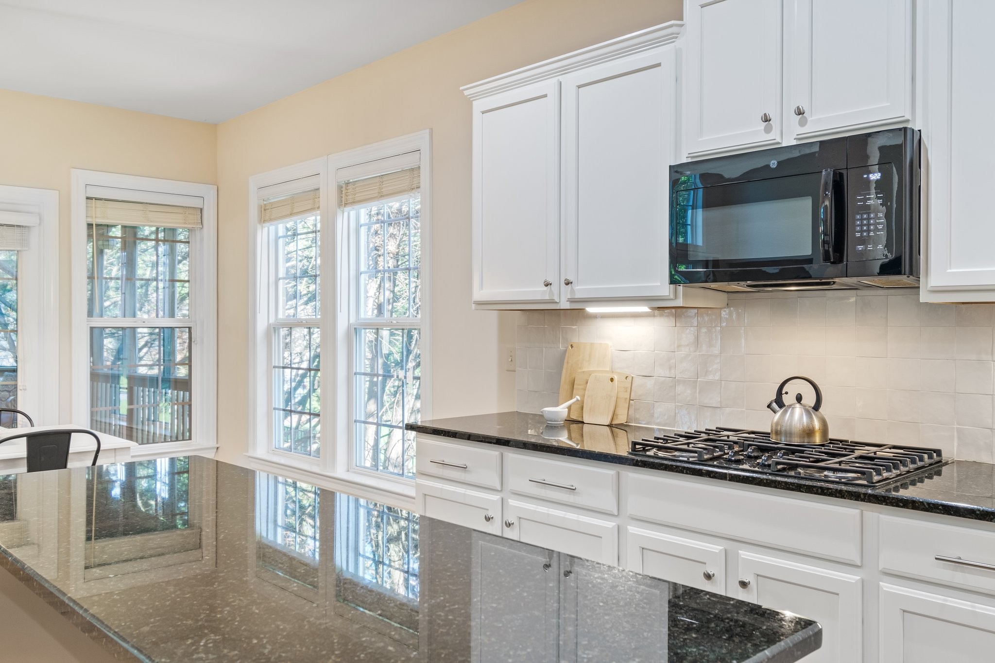 5028 Abington Ridge Lane Franklin, TN 37067 - Photo 27 of 68 a kitchen with stainless steel appliances granite countertop white cabinets and a stove top oven