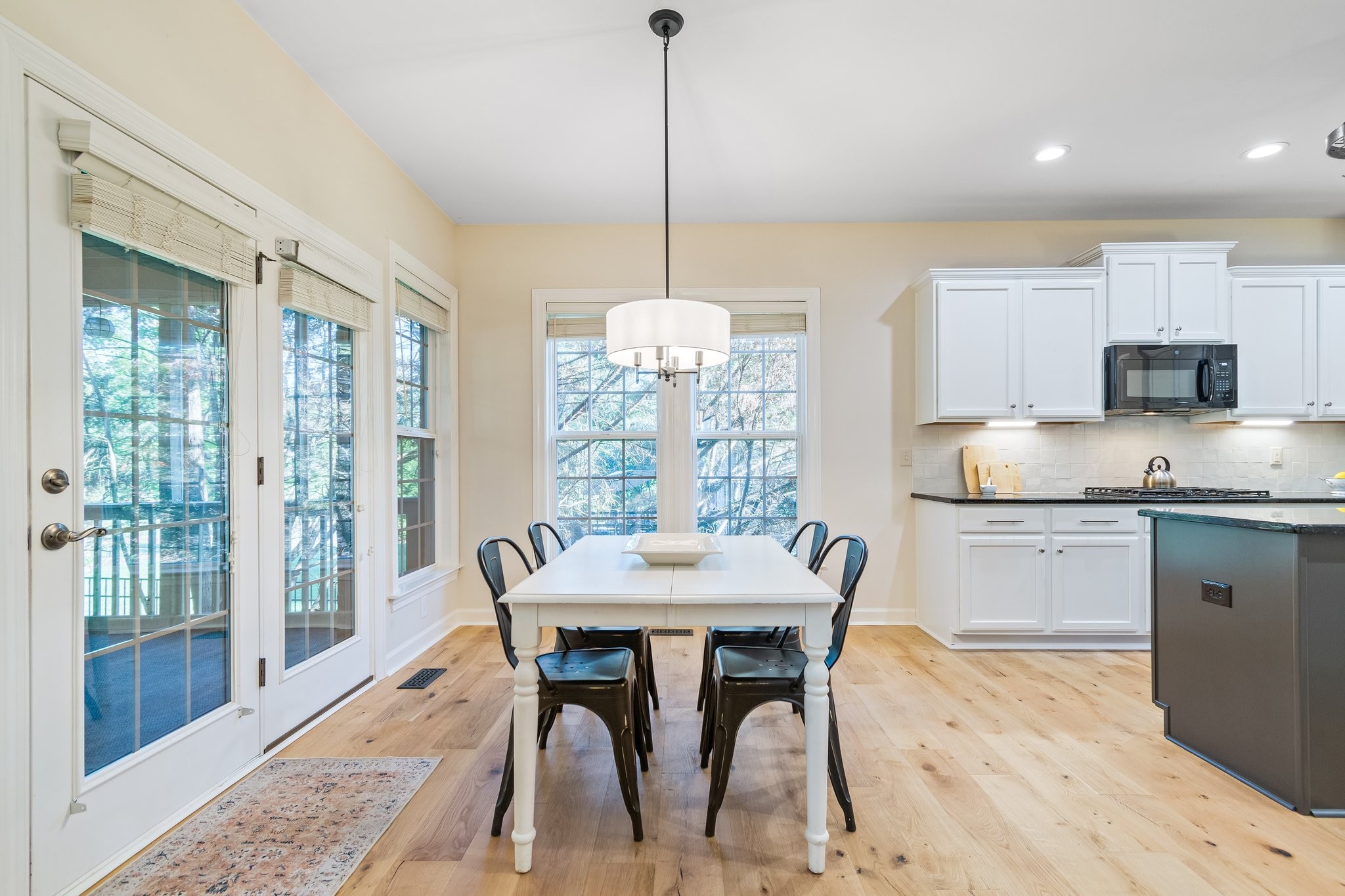 5028 Abington Ridge Lane Franklin, TN 37067 - Photo 31 of 68 a kitchen with stainless steel appliances granite countertop a dining table chairs and a large window