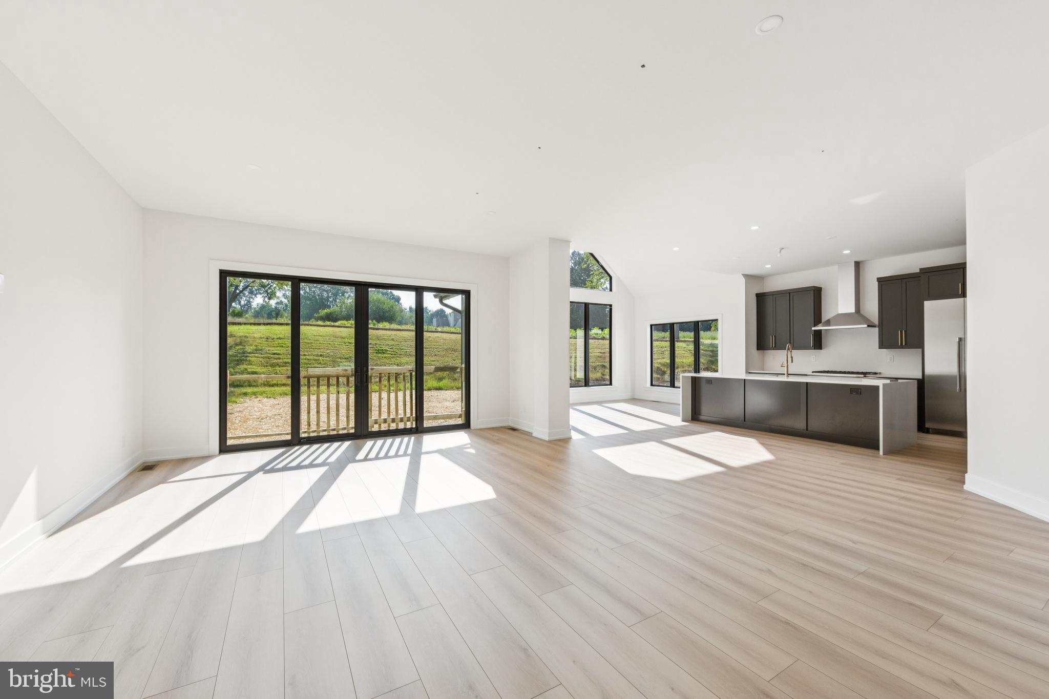 736 Northbrook Road, Unit L2 Kennett Square, PA 19348 - Photo 14 of 60 a open kitchen with granite countertop a stove top oven a sink and white cabinets