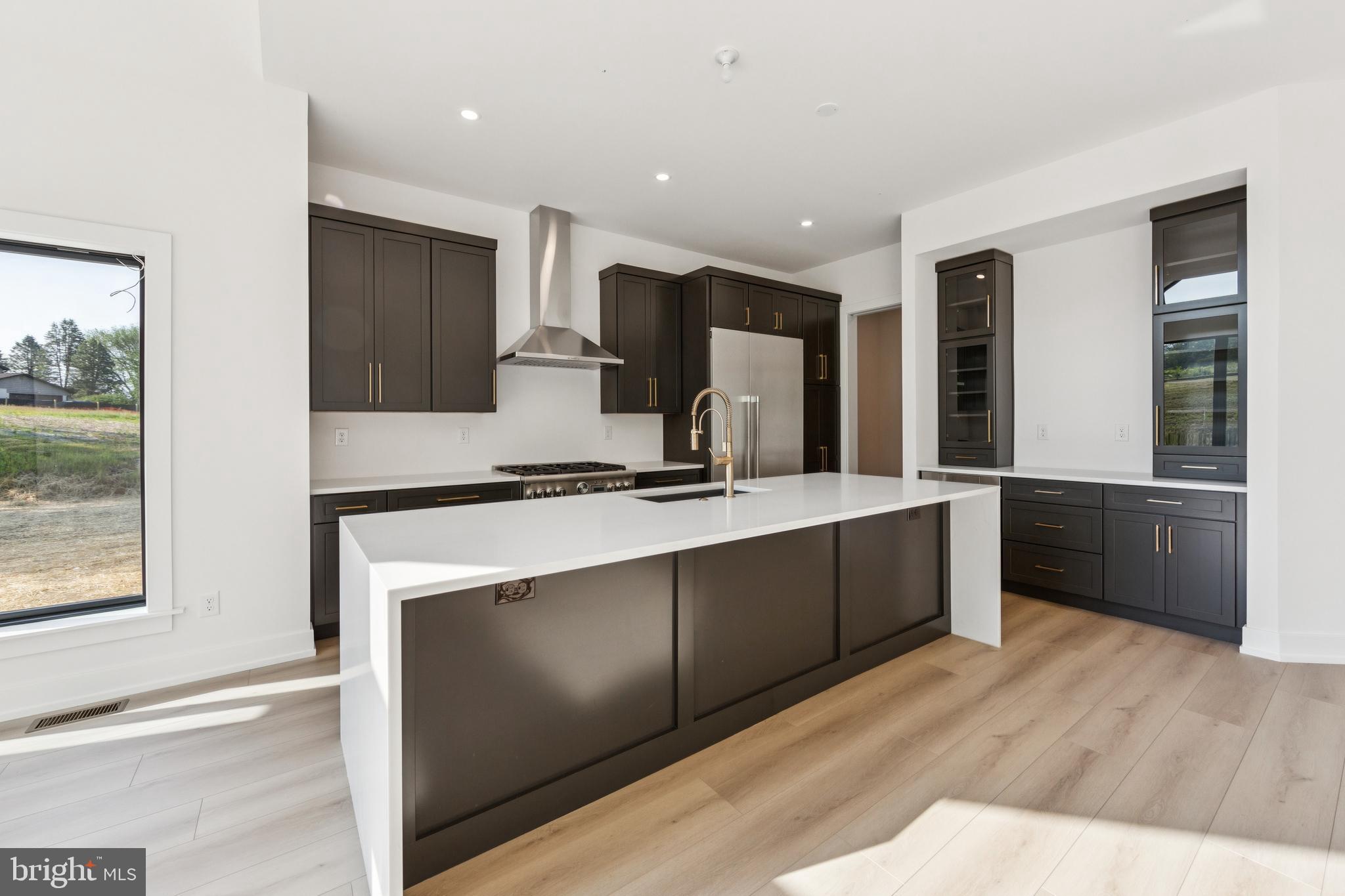 736 Northbrook Road, Unit L2 Kennett Square, PA 19348 - Photo 16 of 60 a kitchen with stainless steel appliances kitchen island granite countertop a stove a sink and a refrigerator