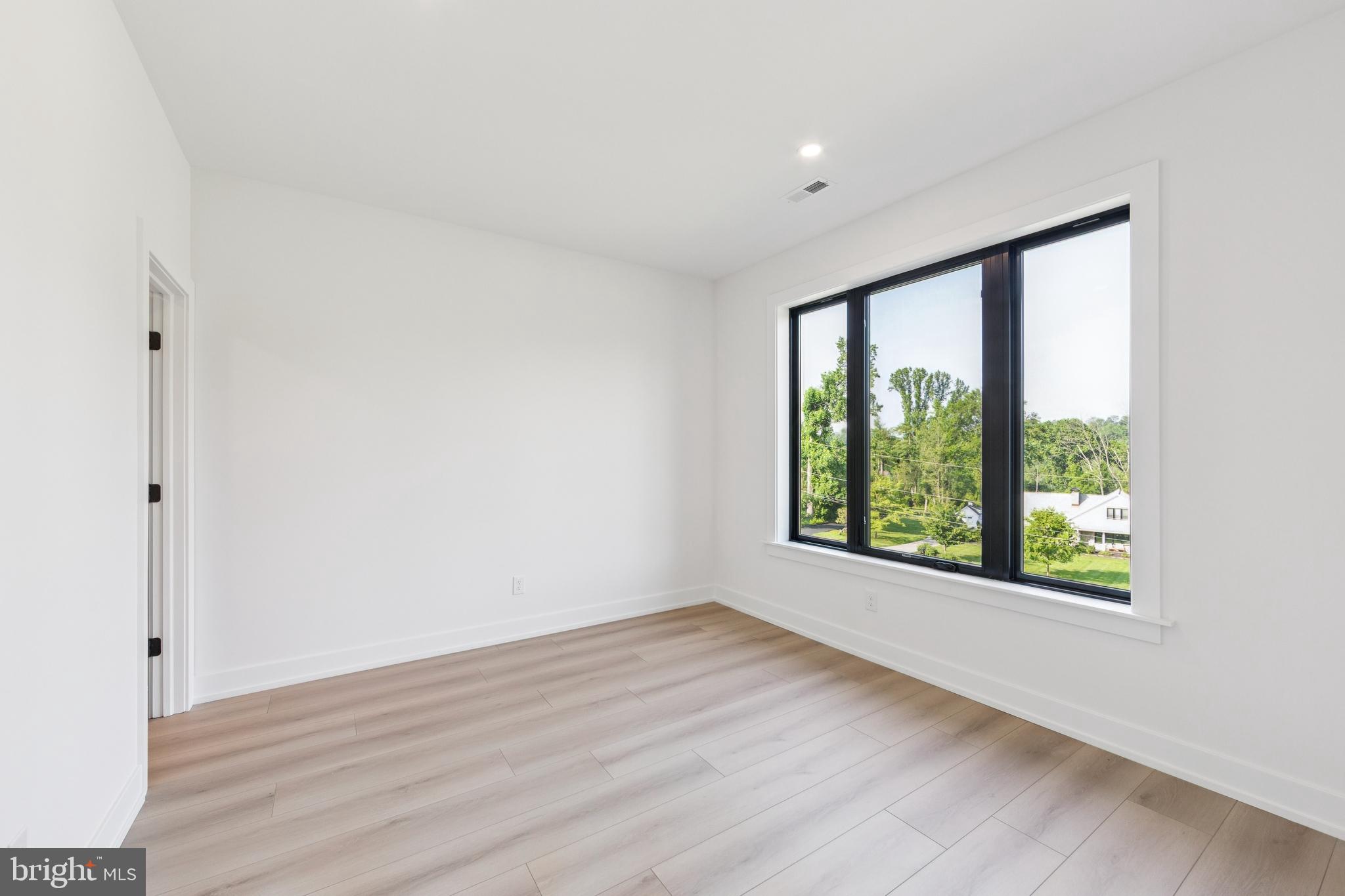 736 Northbrook Road, Unit L2 Kennett Square, PA 19348 - Photo 39 of 60 a view of an empty room with wooden floor and a window