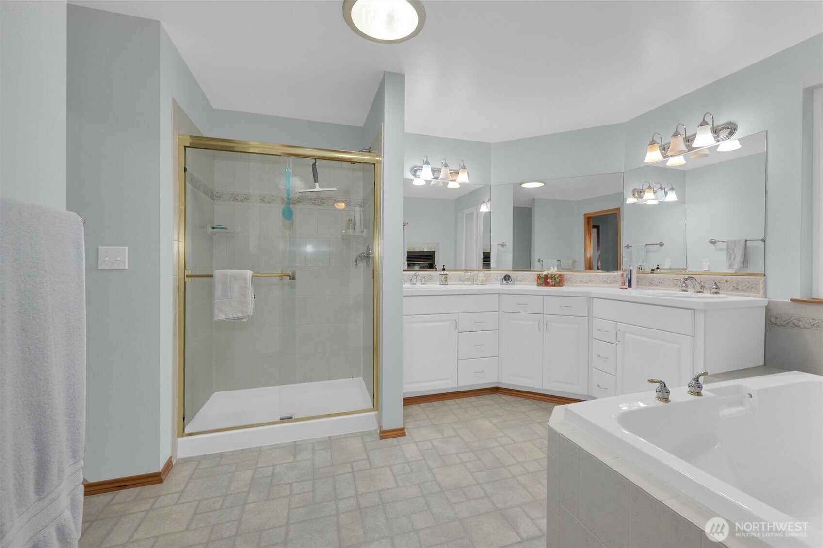15403 Southeast 254th Street Covington, WA 98042 - Photo 12 of 22 a bathroom with a sink a toilet a mirror and shower