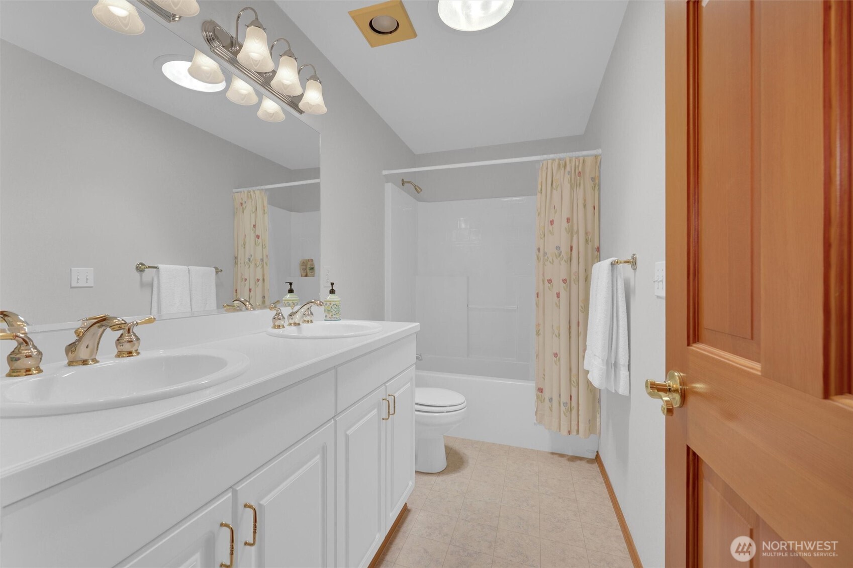 15403 Southeast 254th Street Covington, WA 98042 - Photo 17 of 22 a bathroom with a double vanity sink mirror and toilet