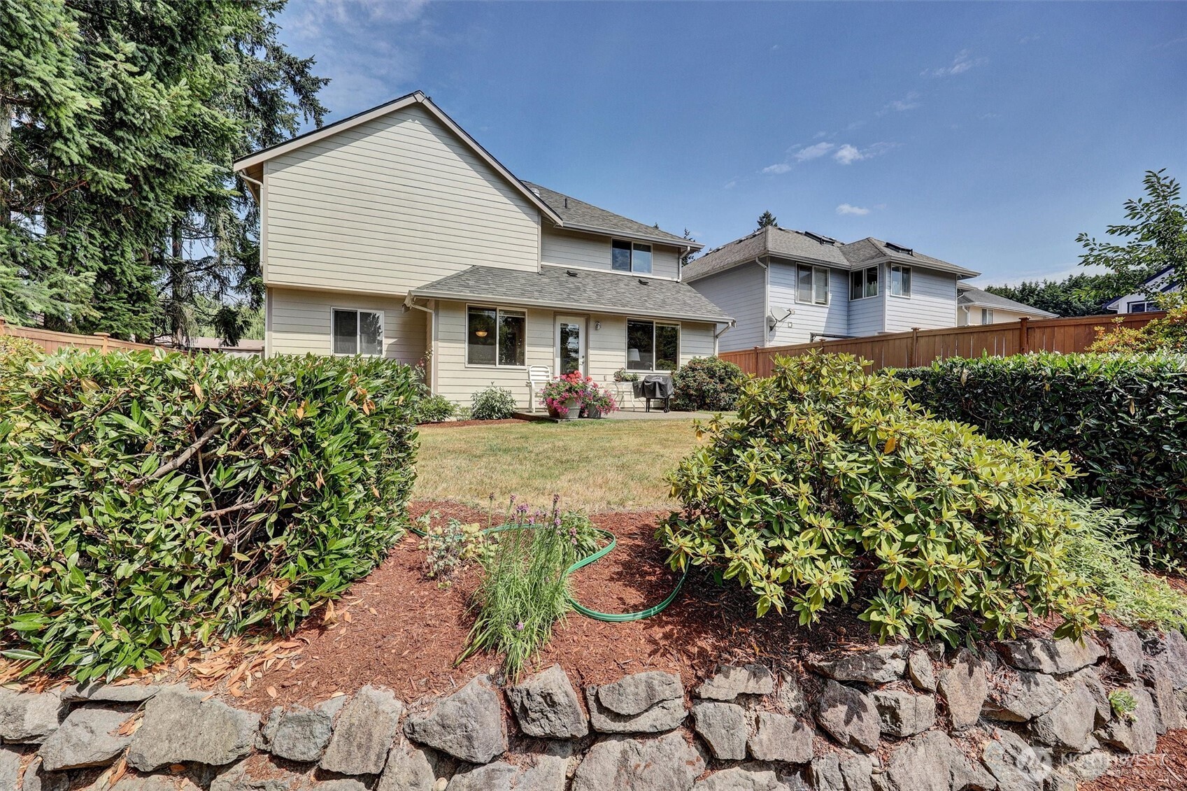 15403 Southeast 254th Street Covington, WA 98042 - Photo 22 of 22 a front view of a house with a yard and potted plants