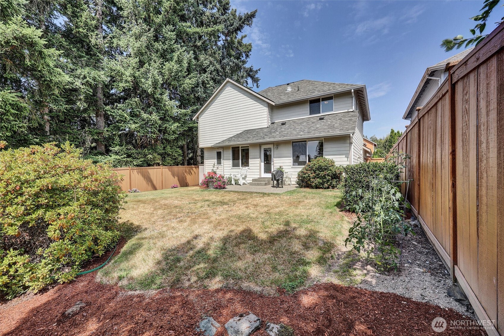 15403 Southeast 254th Street Covington, WA 98042 - Photo 4 of 22 a front view of a house with a yard