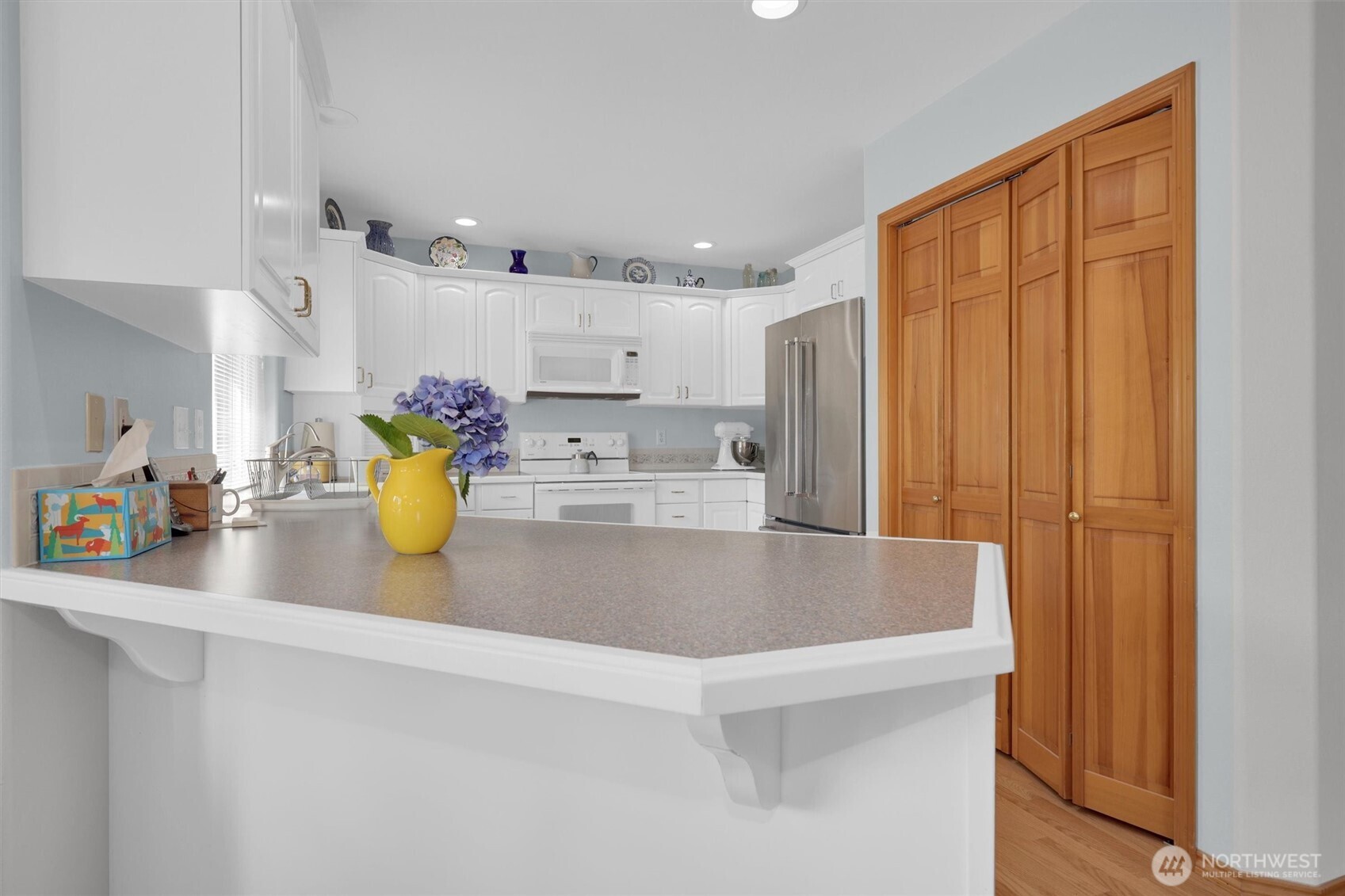 15403 Southeast 254th Street Covington, WA 98042 - Photo 6 of 22 a view of kitchen with a sink cabinets and wooden floor