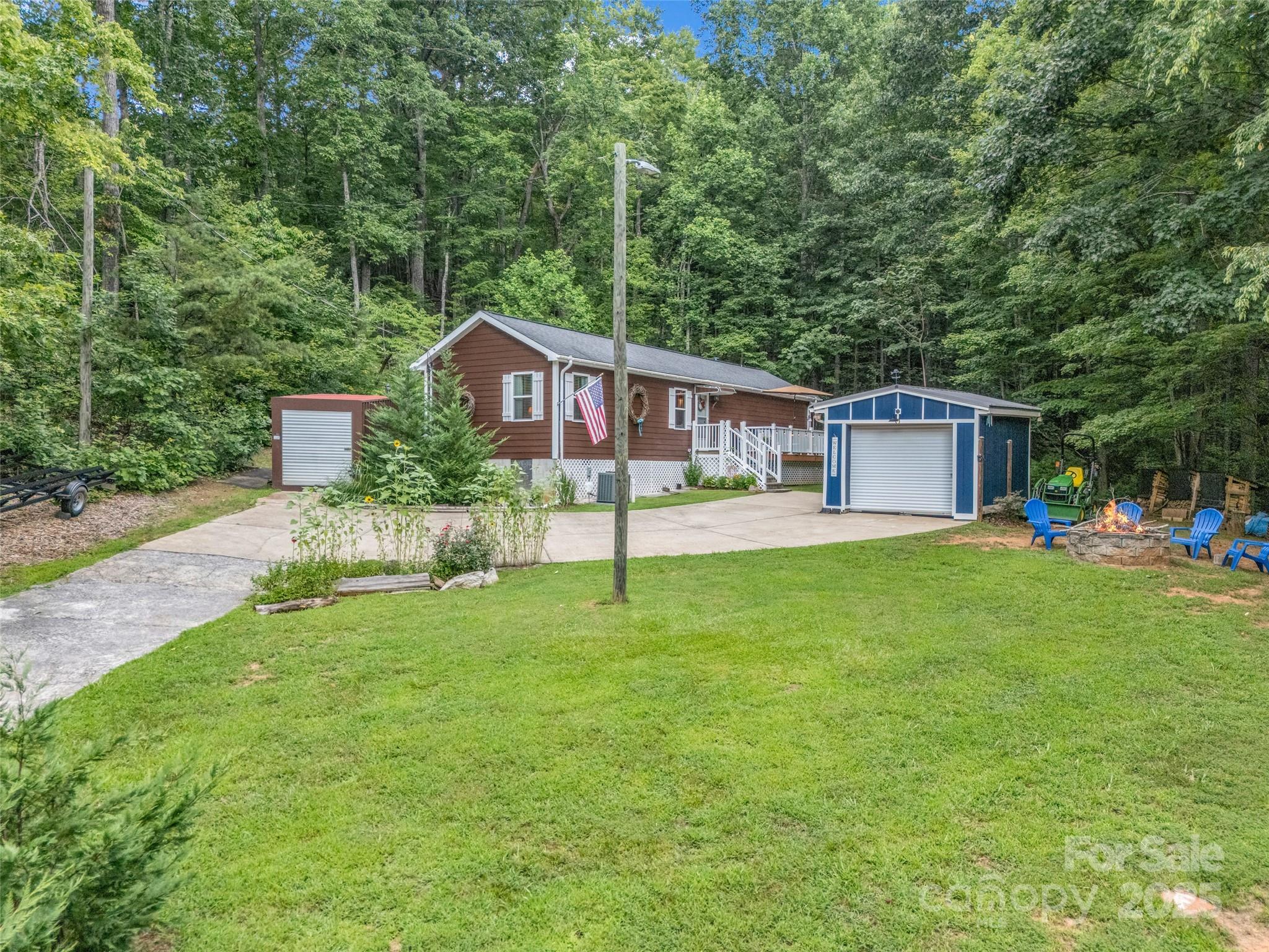 479 Camp Hill Road Mill Spring, NC 28756 - Photo 1 of 48 a view of a house with backyard and sitting area