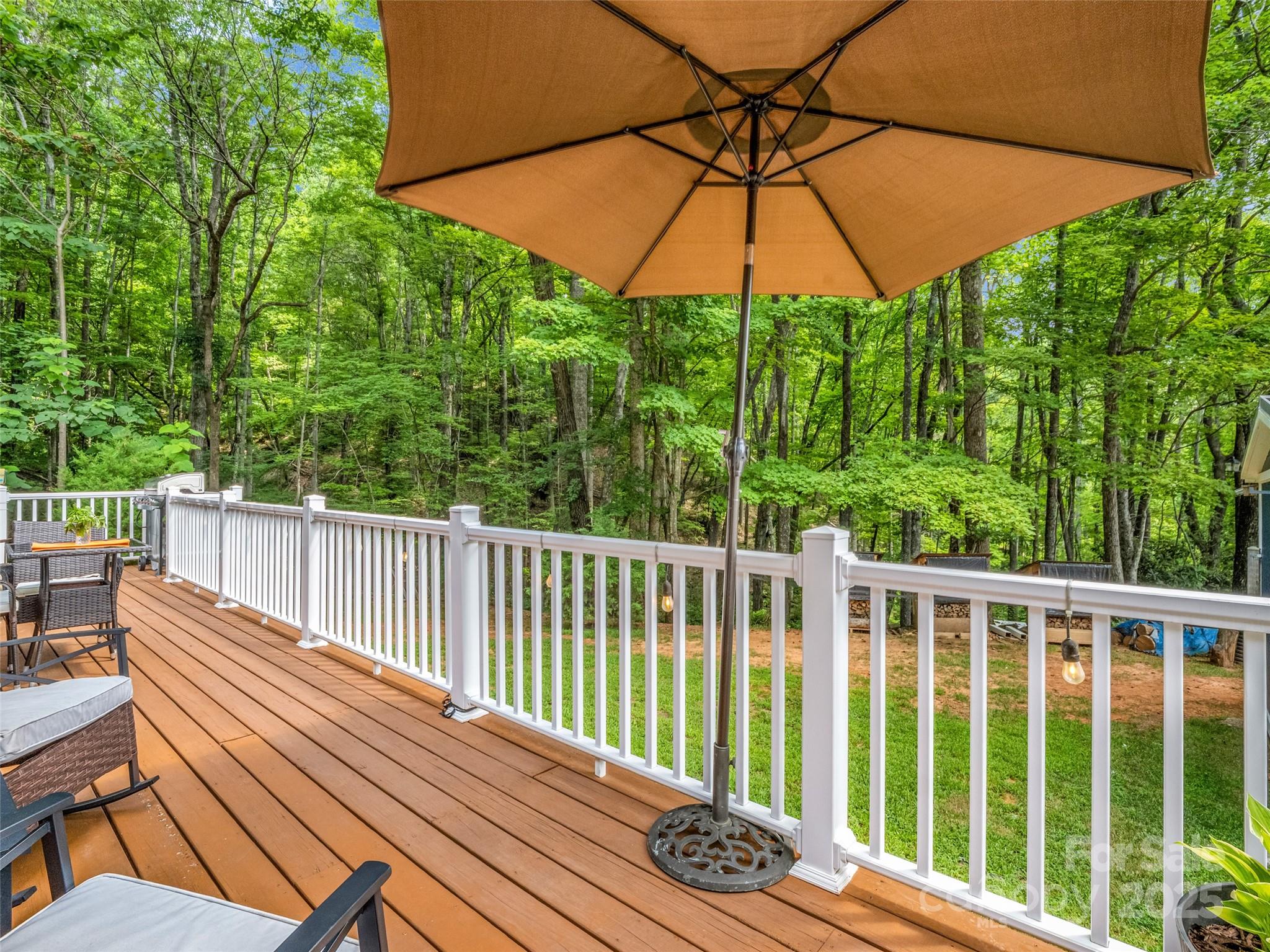 479 Camp Hill Road Mill Spring, NC 28756 - Photo 11 of 48 a view of a wooden deck with furniture