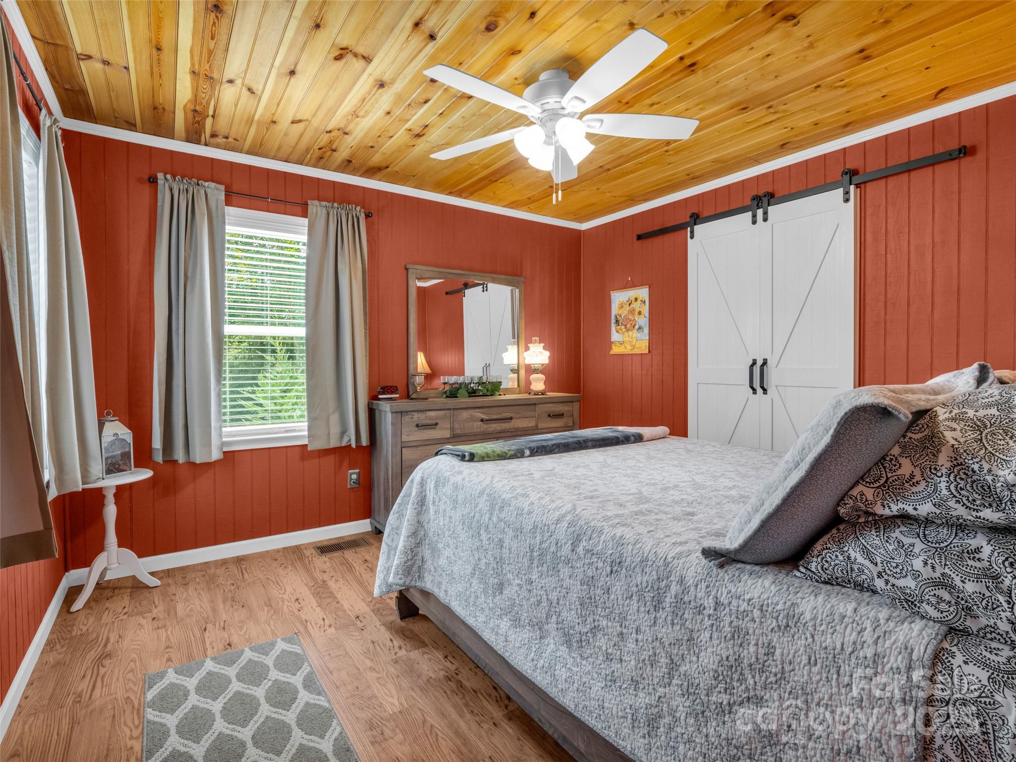 479 Camp Hill Road Mill Spring, NC 28756 - Photo 20 of 48 a bed sitting in a spacious bedroom next to a window