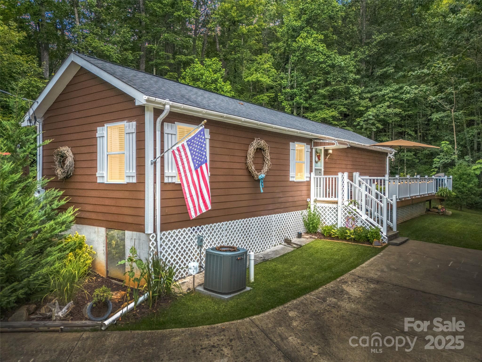 479 Camp Hill Road Mill Spring, NC 28756 - Photo 2 of 48 a front view of a house with garden