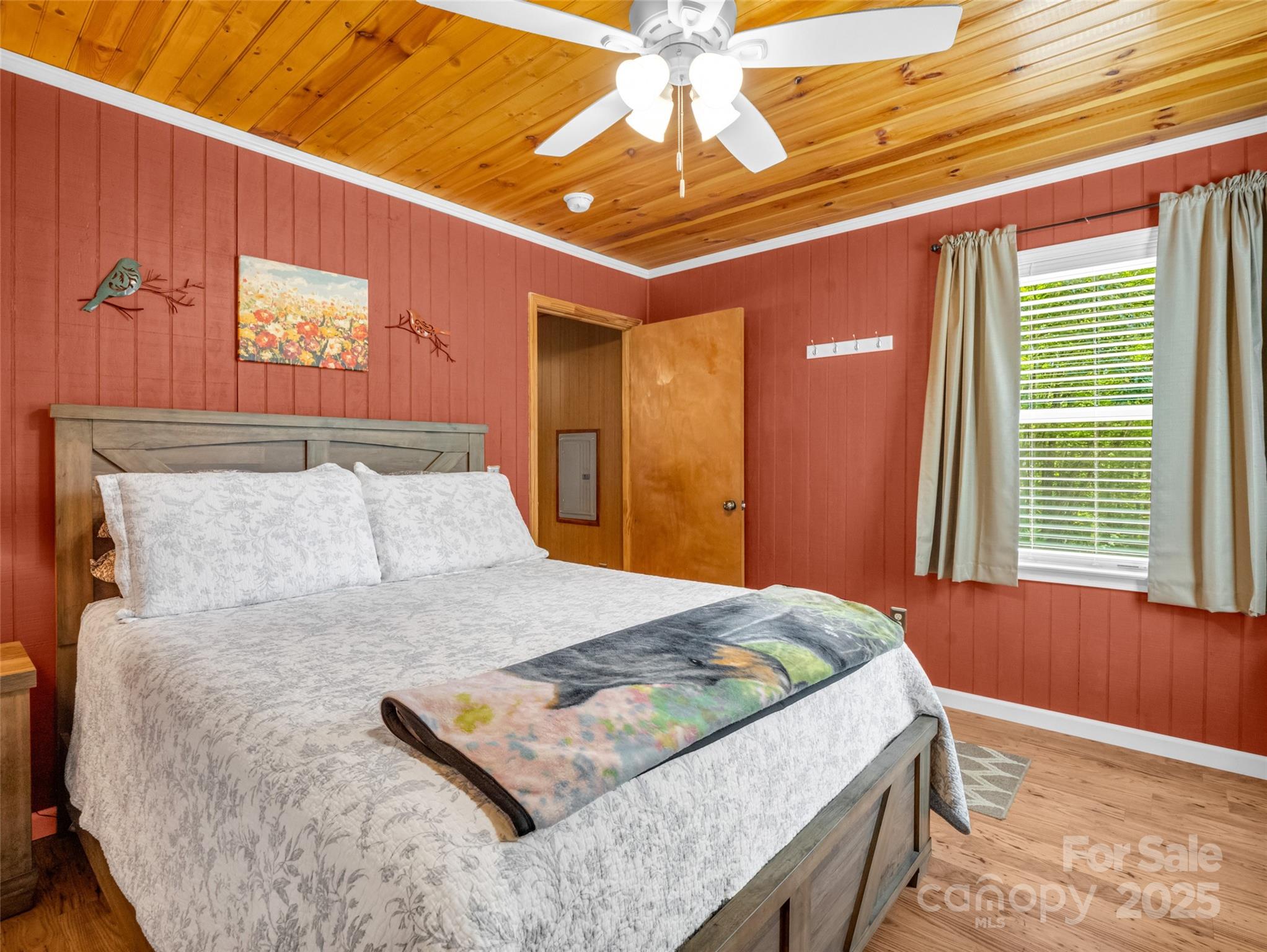 479 Camp Hill Road Mill Spring, NC 28756 - Photo 22 of 48 a bed sitting in a bedroom next to a window