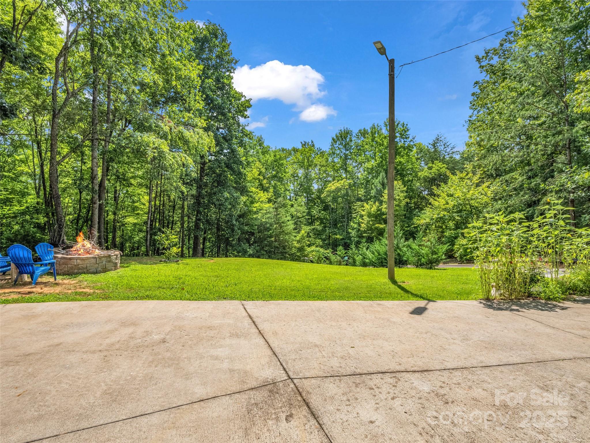 479 Camp Hill Road Mill Spring, NC 28756 - Photo 29 of 48 a green field sitting in the middle of a yard