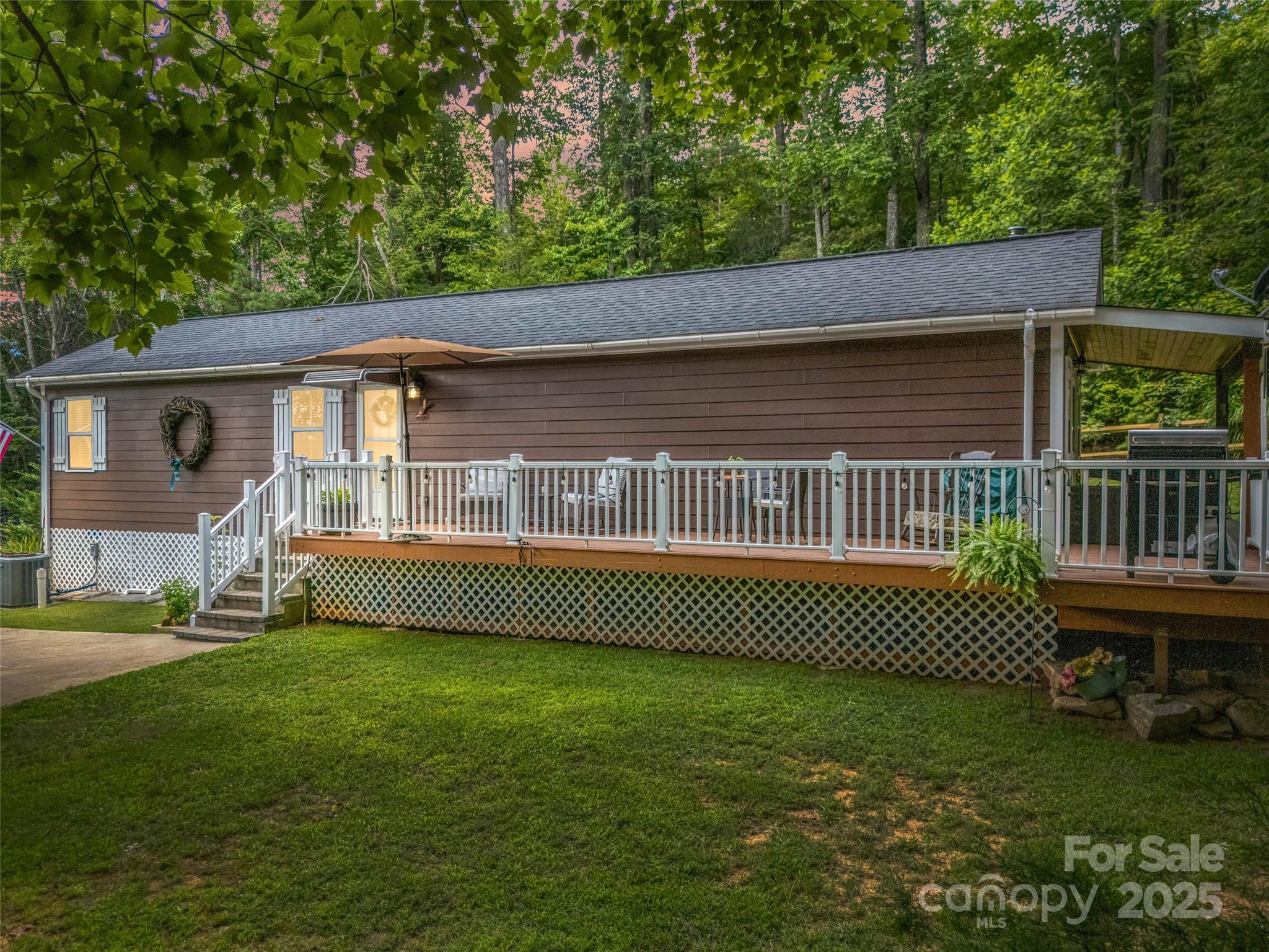 479 Camp Hill Road Mill Spring, NC 28756 - Photo 40 of 48 a front view of a house with a garden