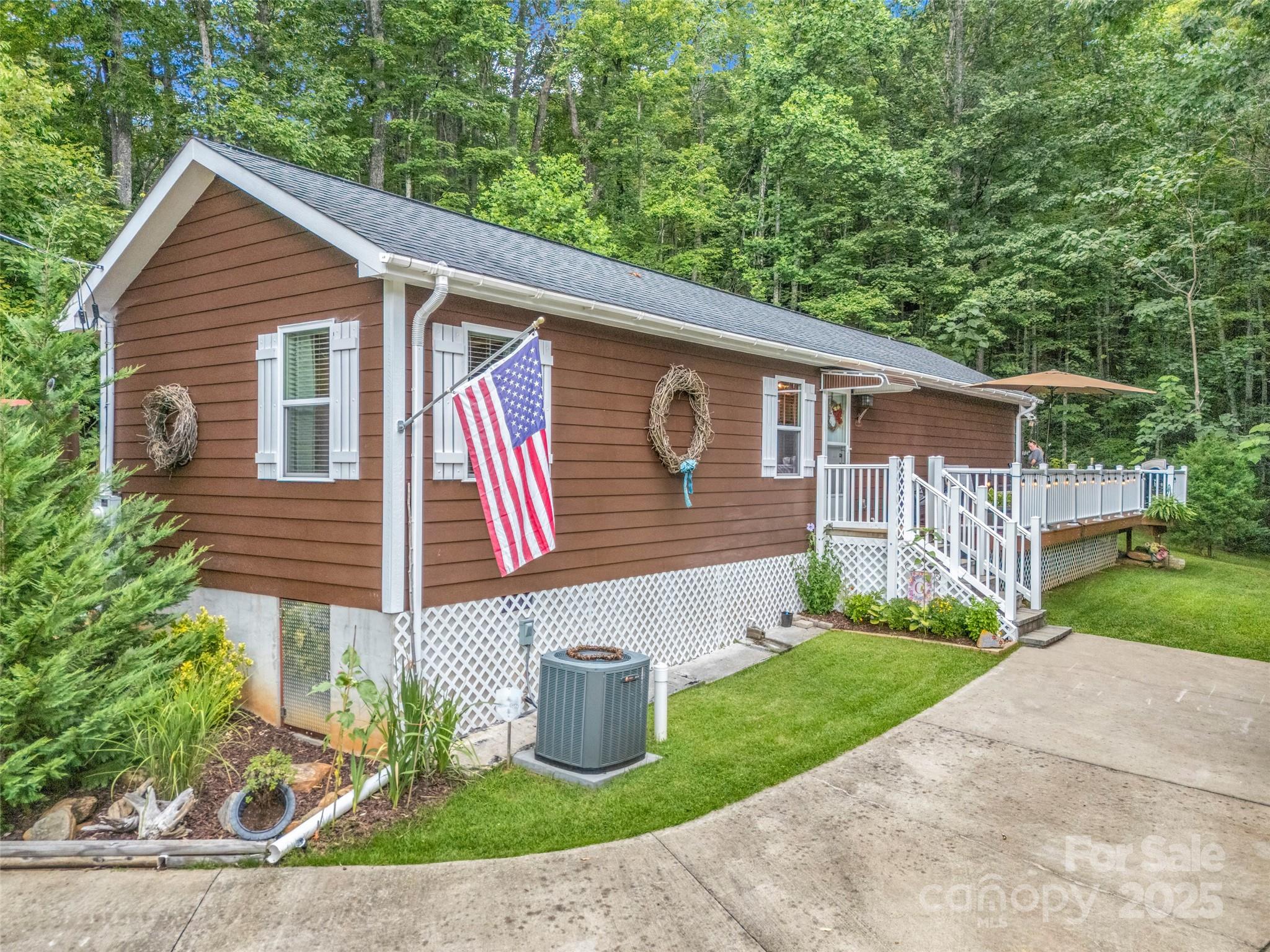 479 Camp Hill Road Mill Spring, NC 28756 - Photo 5 of 48 a front view of a house with garden