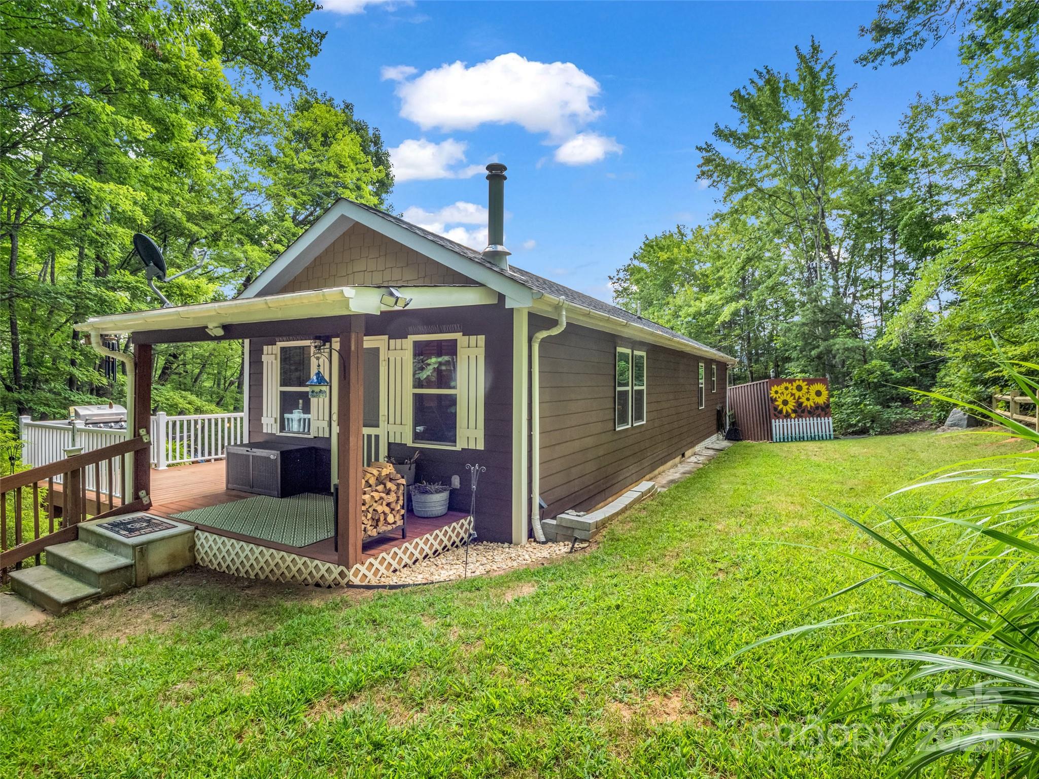 479 Camp Hill Road Mill Spring, NC 28756 - Photo 7 of 48 a view of a house with backyard porch and sitting area