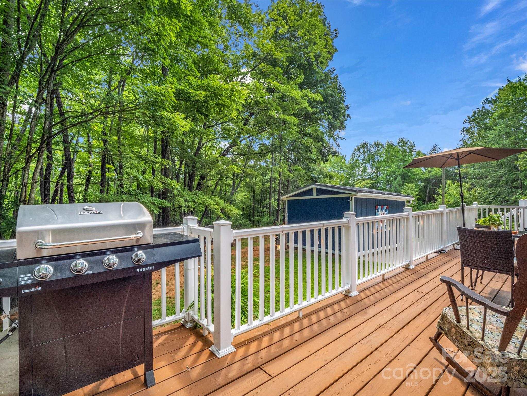 479 Camp Hill Road Mill Spring, NC 28756 - Photo 10 of 48 a view of a deck with a table and chairs with wooden floor