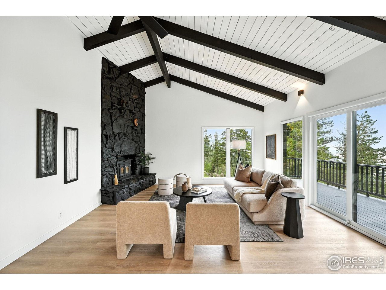 a living room with furniture and a floor to ceiling window