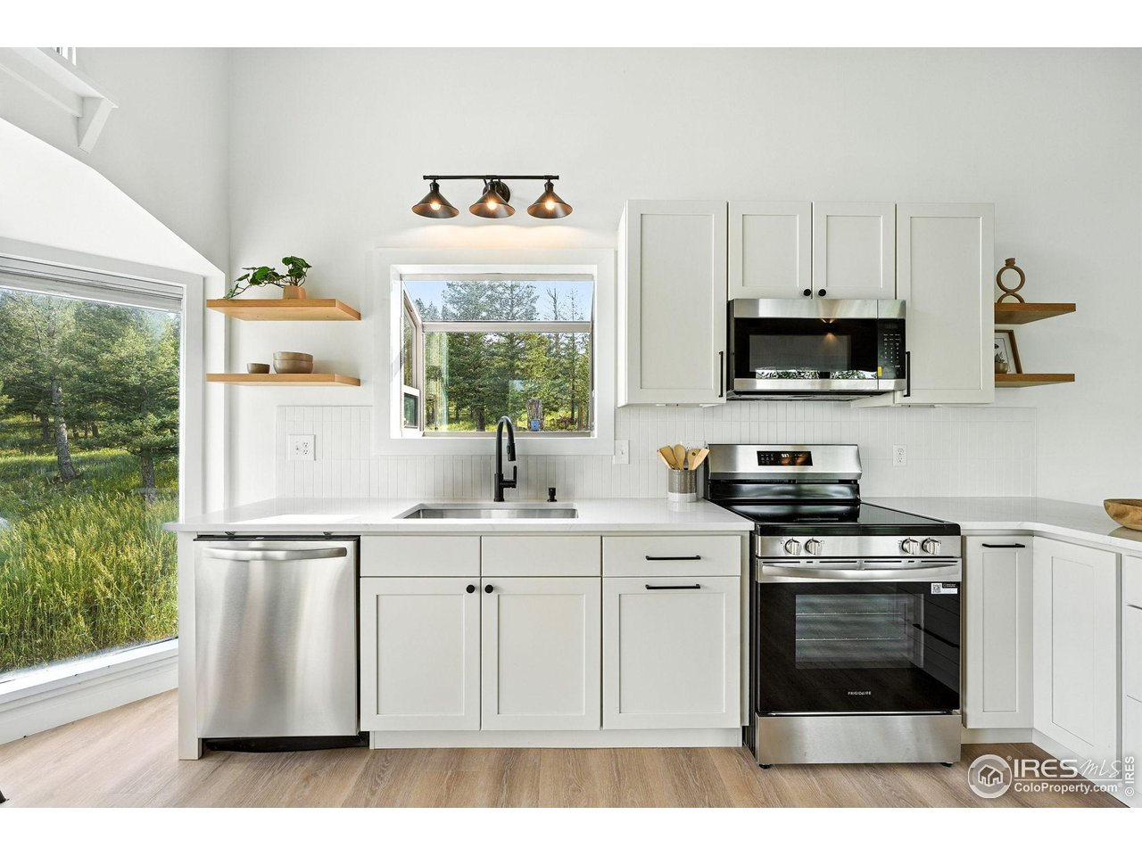 1575 Deer Trail Road Boulder, CO 80302 - Photo 8 of 39 a kitchen with stainless steel appliances a stove a sink and a window
