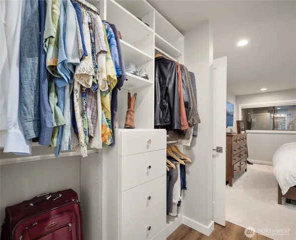 a large bed sitting in a bedroom and a mirror