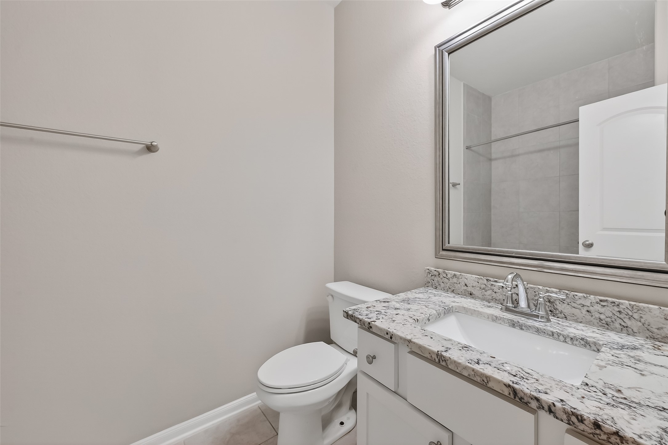 16226 Rattlesnake Run Trail Cypress, TX 77433 - Photo 24 of 29 a bathroom with a granite countertop sink and a toilet