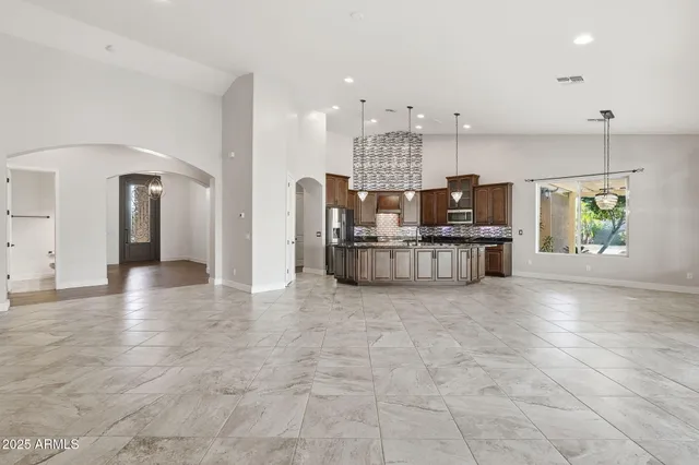 a kitchen with stainless steel appliances granite countertop a stove a sink and a microwave