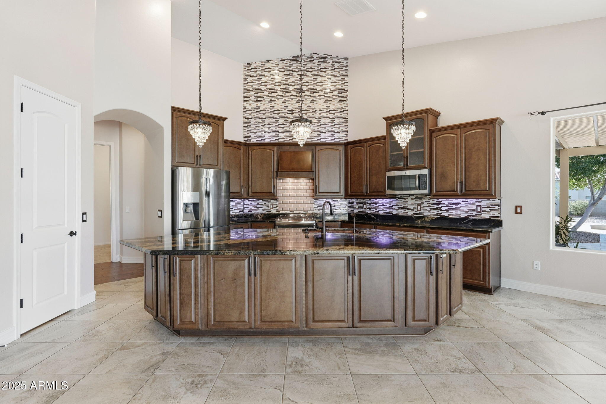 2218 East Brooks Farm Road Gilbert, AZ 85298 - Photo 19 of 55 a kitchen with stainless steel appliances kitchen island granite countertop a sink and cabinets