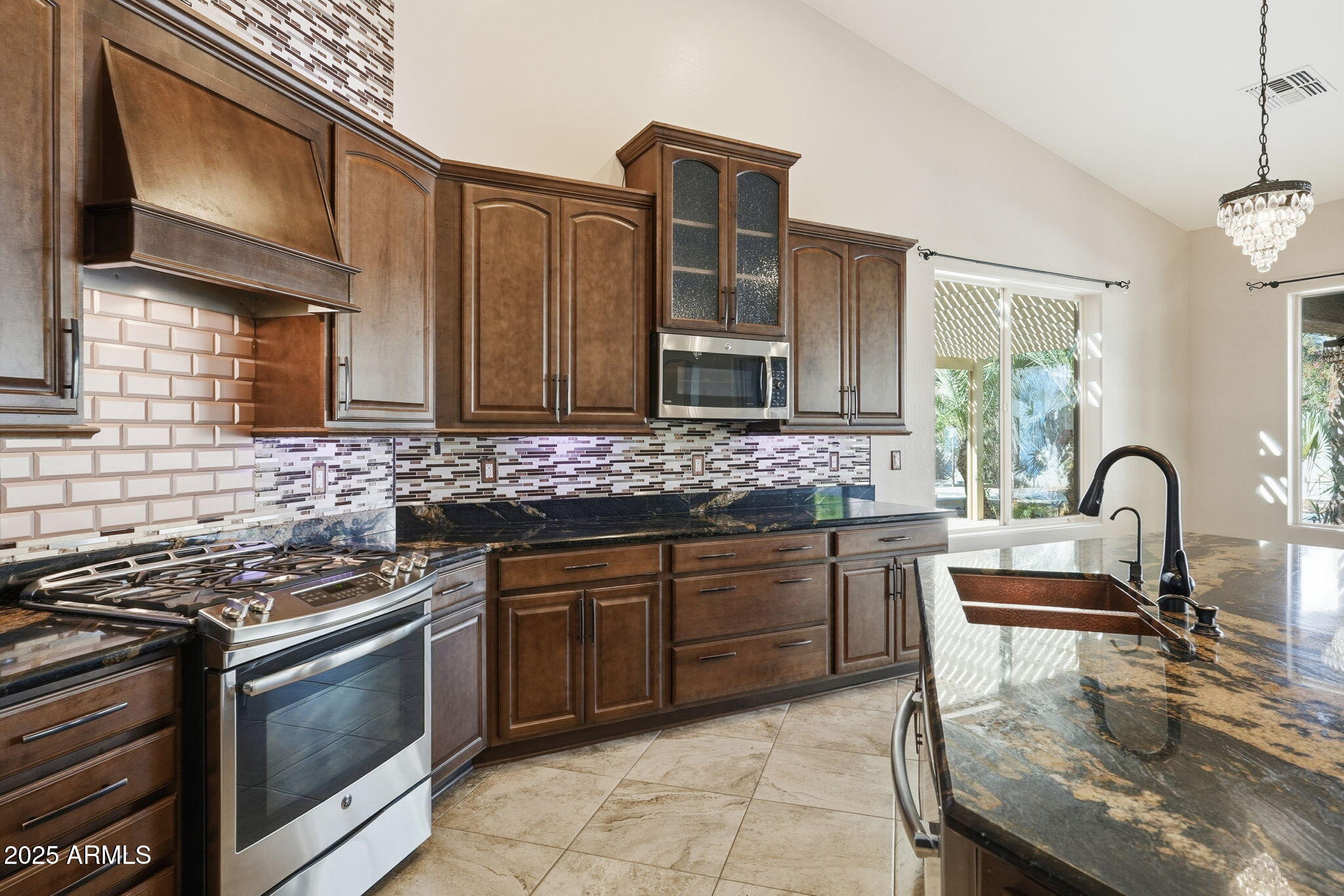 2218 East Brooks Farm Road Gilbert, AZ 85298 - Photo 21 of 55 a kitchen with stainless steel appliances granite countertop a stove a sink and a microwave