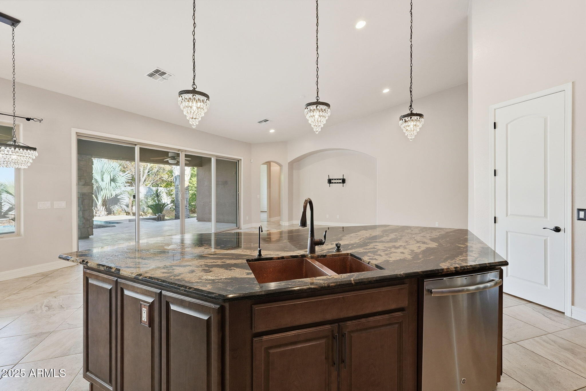 2218 East Brooks Farm Road Gilbert, AZ 85298 - Photo 22 of 55 a kitchen with granite countertop kitchen island a stove a sink a counter space and a window