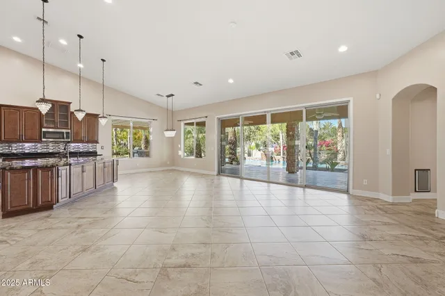 a view of a hallway with wooden floor and a large window