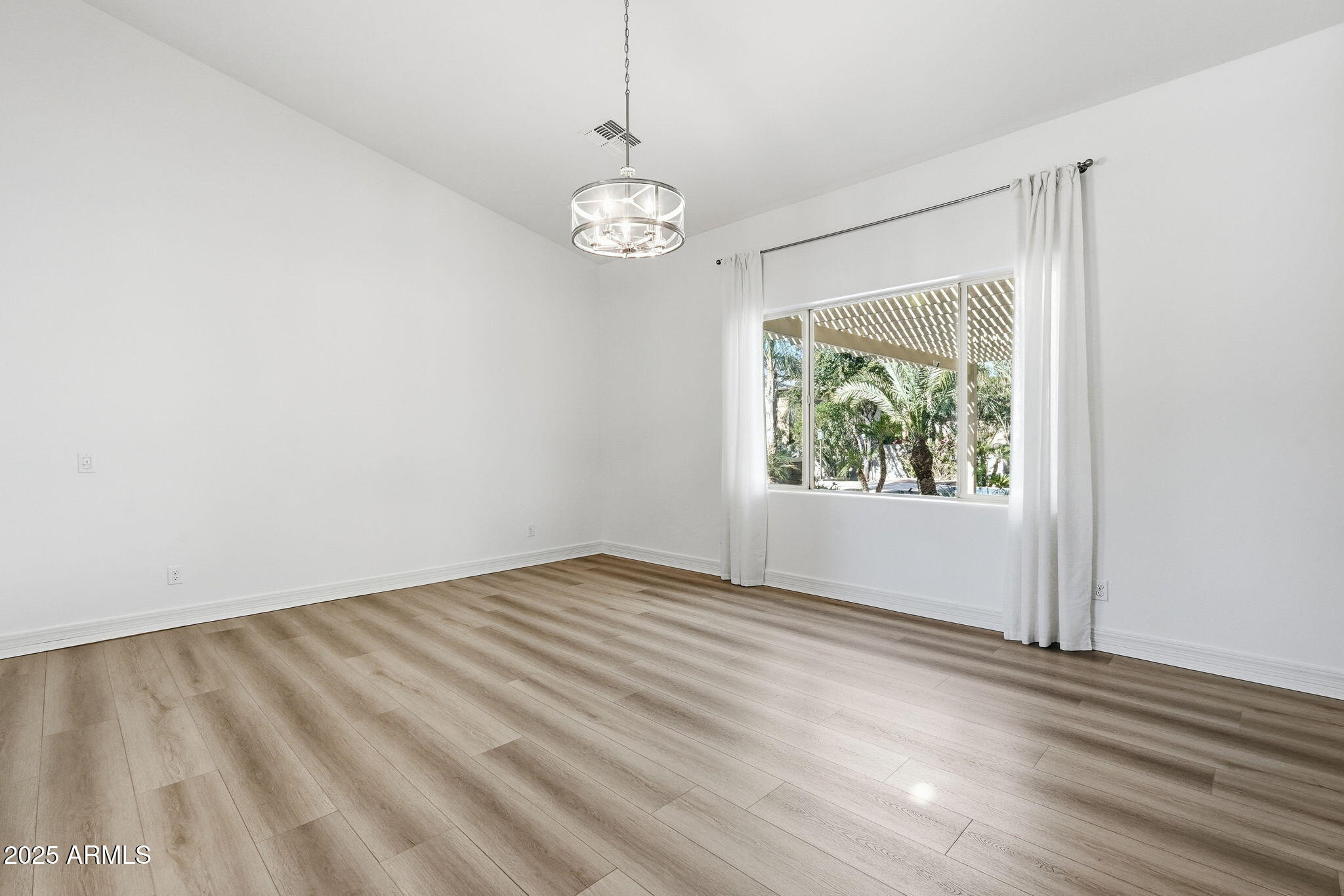2218 East Brooks Farm Road Gilbert, AZ 85298 - Photo 26 of 55 an empty room with wooden floor and windows