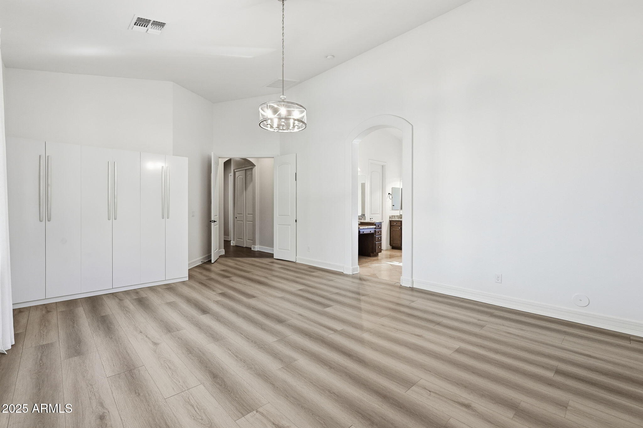 2218 East Brooks Farm Road Gilbert, AZ 85298 - Photo 28 of 55 an empty room with wooden floor and windows