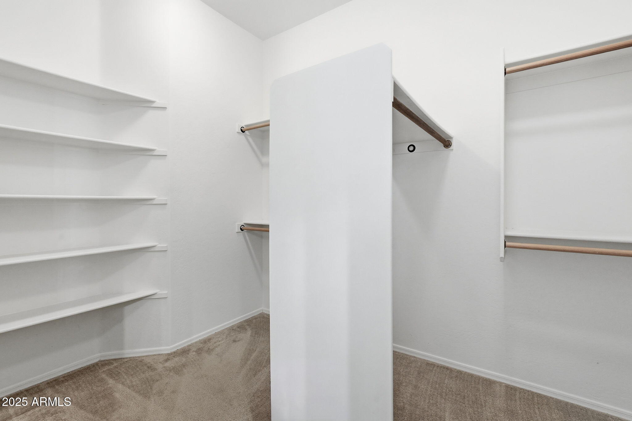 2218 East Brooks Farm Road Gilbert, AZ 85298 - Photo 30 of 55 a view of walk in closet with empty racks