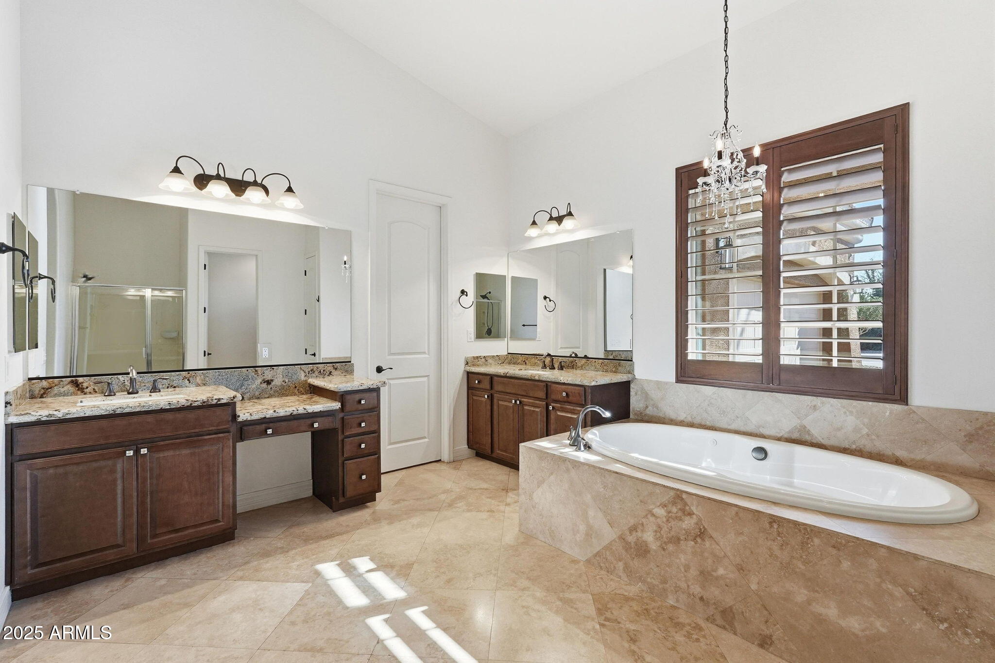 2218 East Brooks Farm Road Gilbert, AZ 85298 - Photo 31 of 55 a spacious bathroom with a granite countertop tub sink and mirror