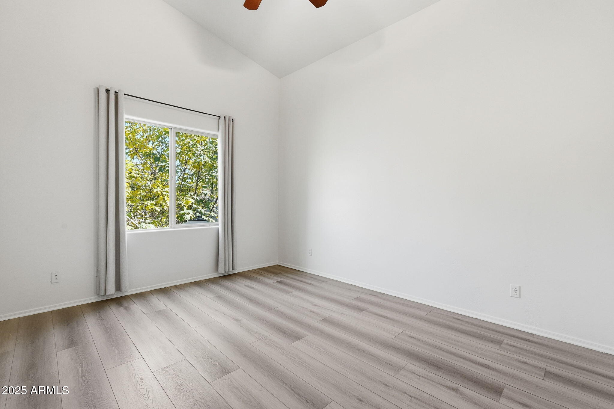 2218 East Brooks Farm Road Gilbert, AZ 85298 - Photo 36 of 55 a view of an empty room with wooden floor and a window