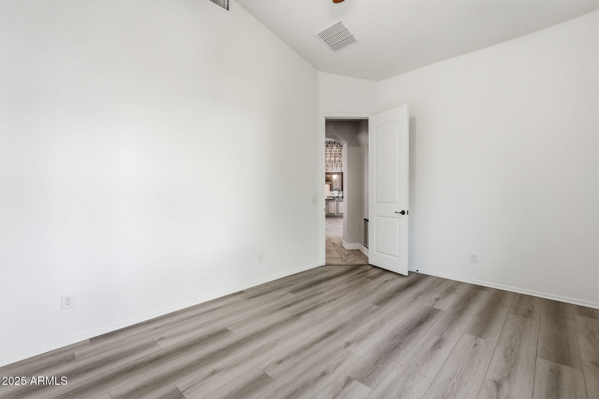 2218 East Brooks Farm Road Gilbert, AZ 85298 - Photo 39 of 55 an empty room with wooden floor