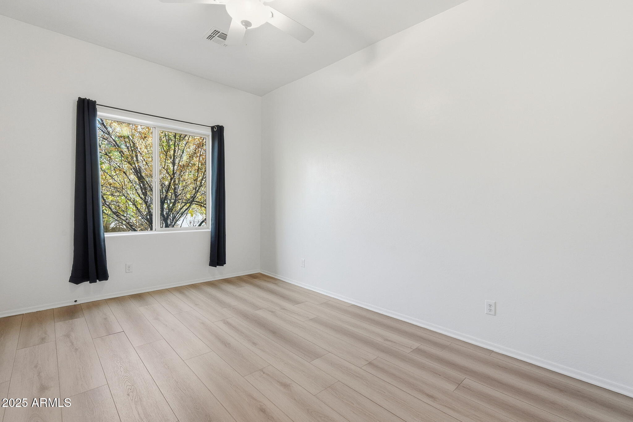 2218 East Brooks Farm Road Gilbert, AZ 85298 - Photo 40 of 55 an empty room with wooden floor and windows