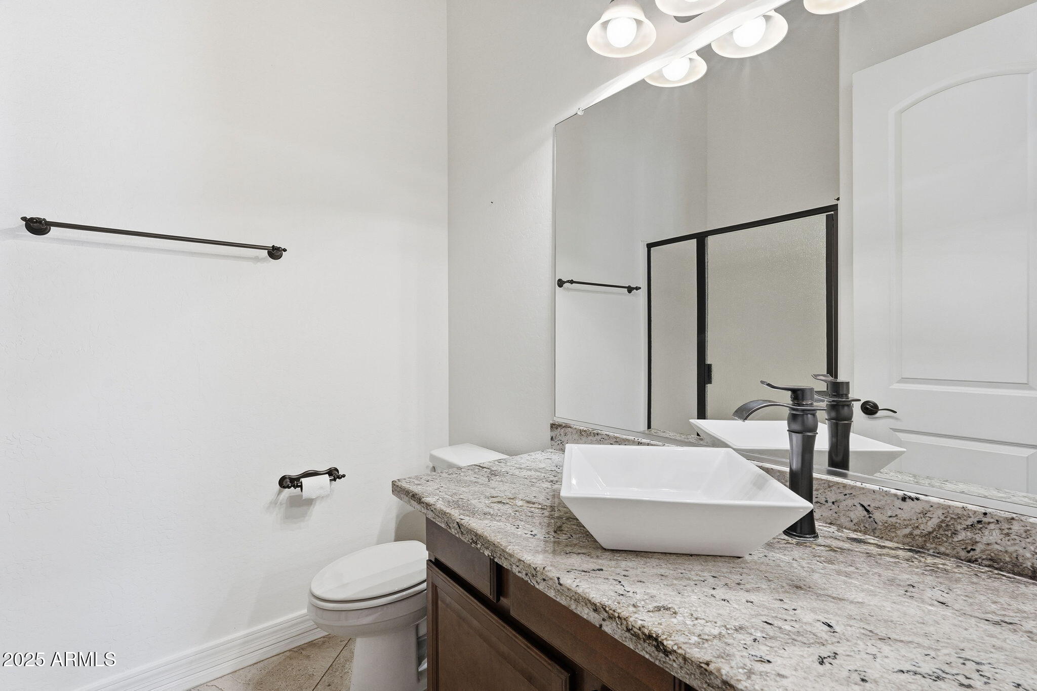 2218 East Brooks Farm Road Gilbert, AZ 85298 - Photo 44 of 55 a bathroom with a granite countertop sink a toilet and a mirror