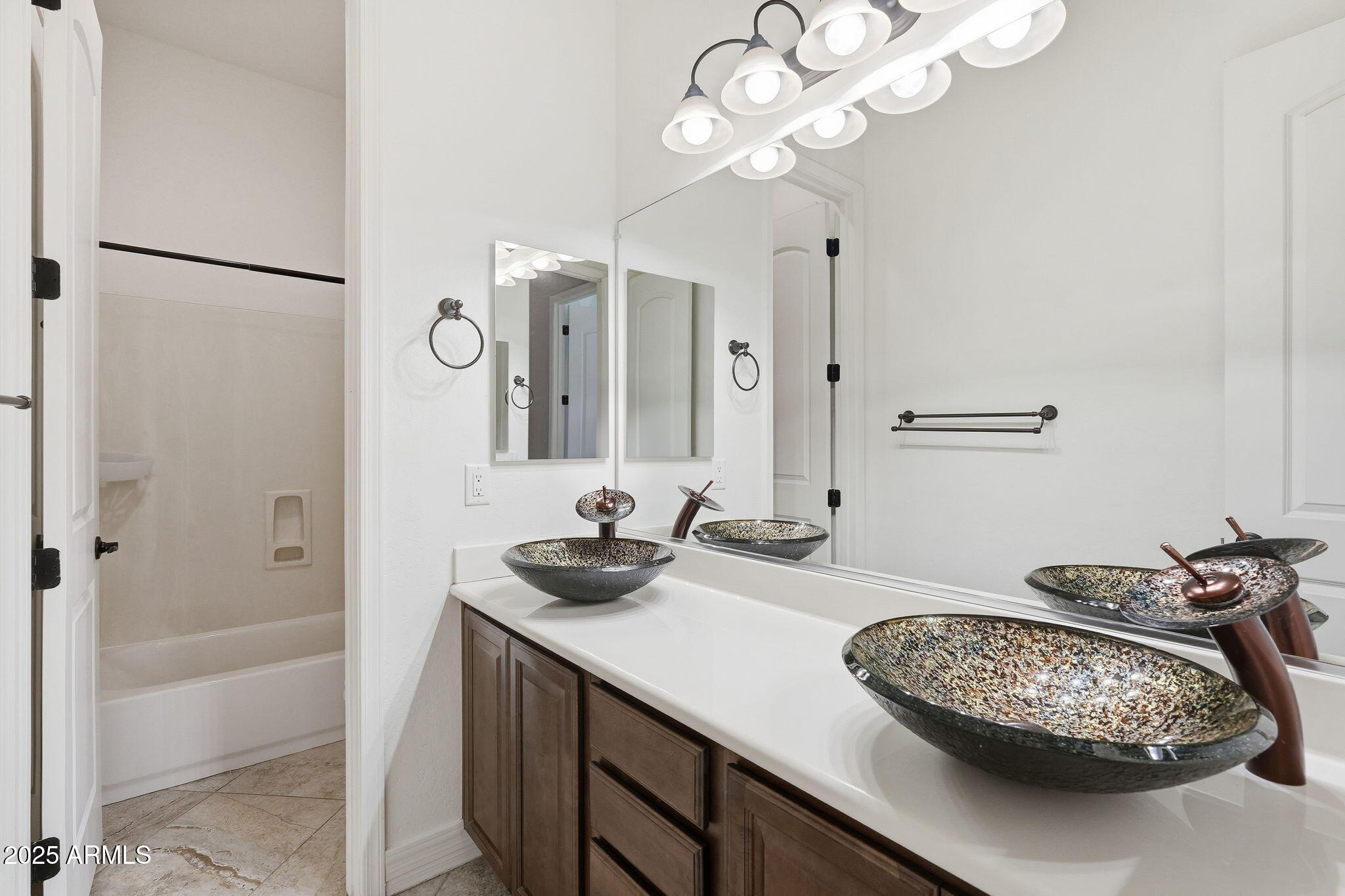 2218 East Brooks Farm Road Gilbert, AZ 85298 - Photo 45 of 55 a bathroom with a sink a bathtub and a mirror