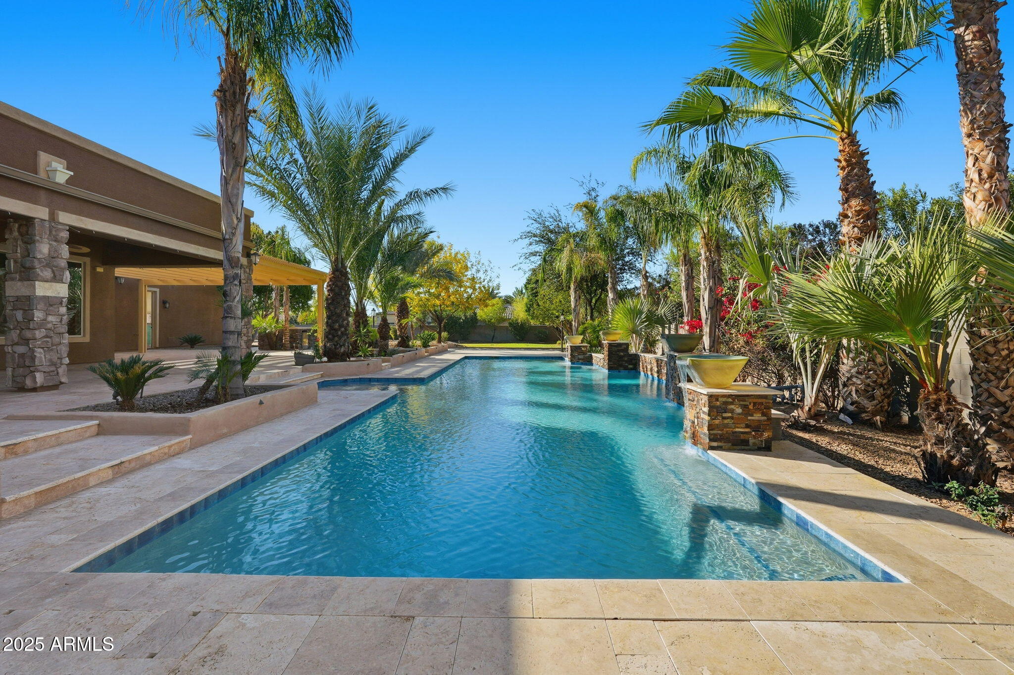 2218 East Brooks Farm Road Gilbert, AZ 85298 - Photo 6 of 55 a view of a swimming pool with a patio