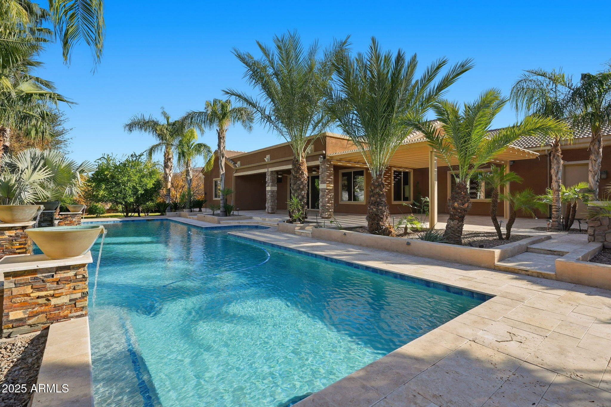 2218 East Brooks Farm Road Gilbert, AZ 85298 - Photo 7 of 55 a view of a swimming pool with a patio