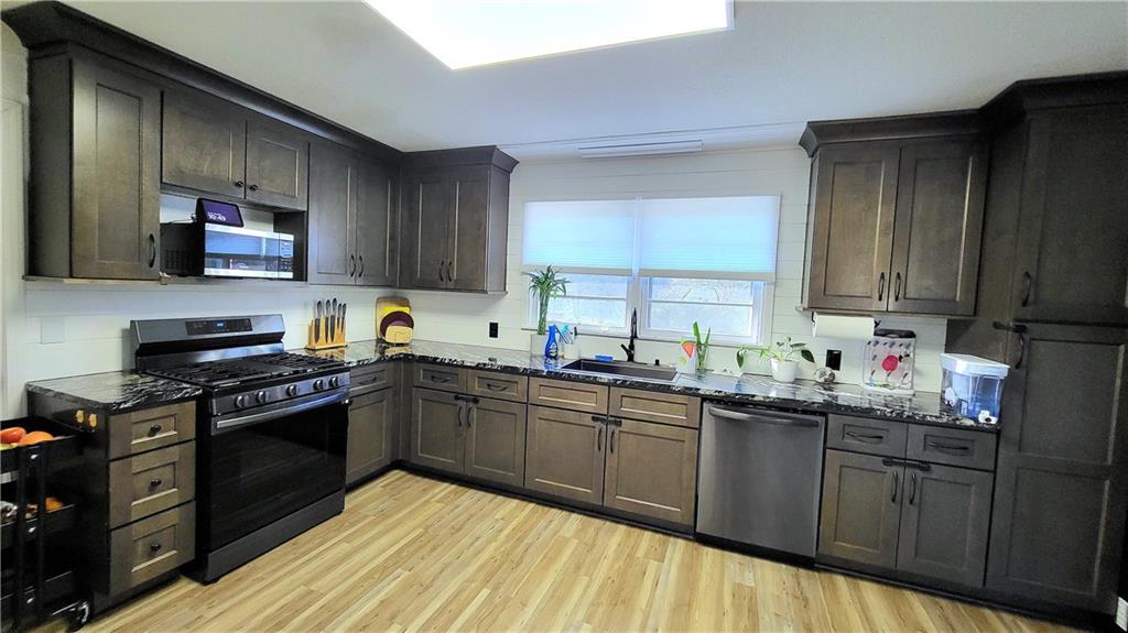 2070 Kingston Highway Rome, GA 30161 - Photo 11 of 48 a kitchen with stainless steel appliances granite countertop a sink stove and cabinets