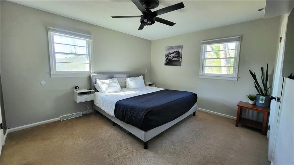 2070 Kingston Highway Rome, GA 30161 - Photo 26 of 48 a bedroom with a bed window and a potted plant on the wall