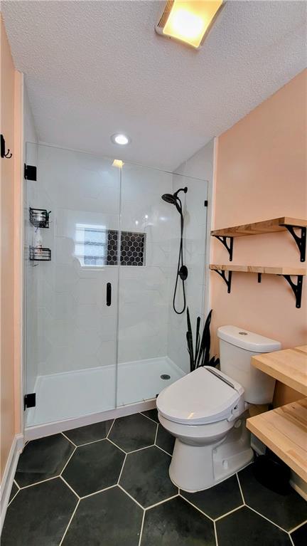 2070 Kingston Highway Rome, GA 30161 - Photo 28 of 48 a bathroom with a toilet and a shower