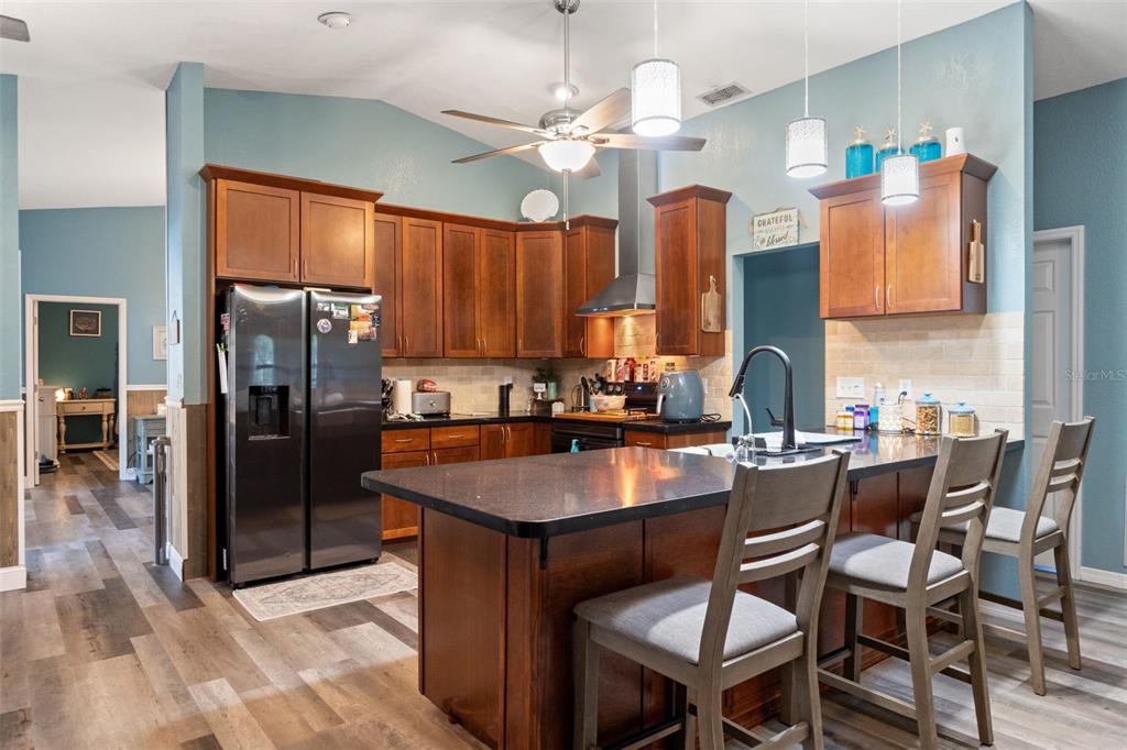 7180 Royal Oak Drive Spring Hill, FL 34607 - Photo 11 of 42 a dining table with chairs and a refrigerator