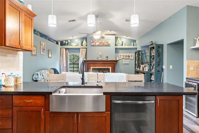 a kitchen with granite countertop a stove and cabinets