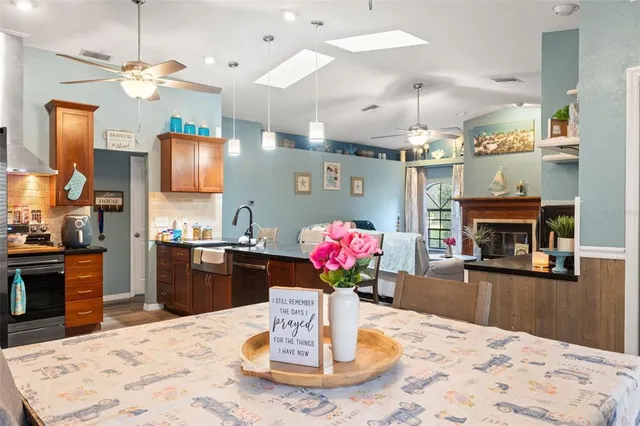a kitchen with kitchen island granite countertop a dining table and chairs