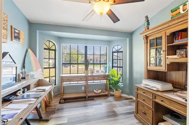 a living room with furniture stove and wooden floor