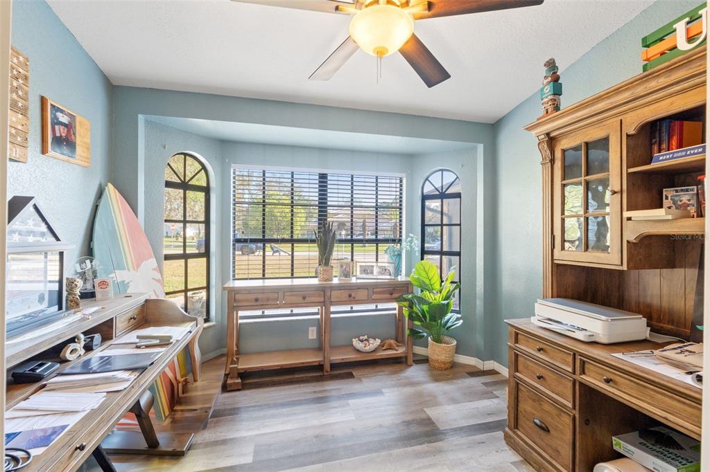 7180 Royal Oak Drive Spring Hill, FL 34607 - Photo 18 of 42 a living room with furniture stove and wooden floor