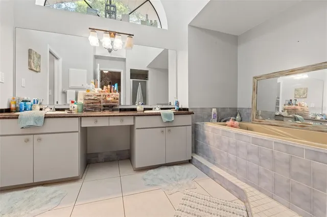 a bathroom with a sink vanity and mirror